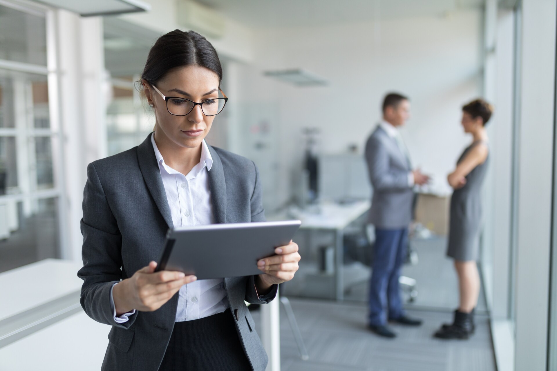 Lady working on a tablet in an office space.