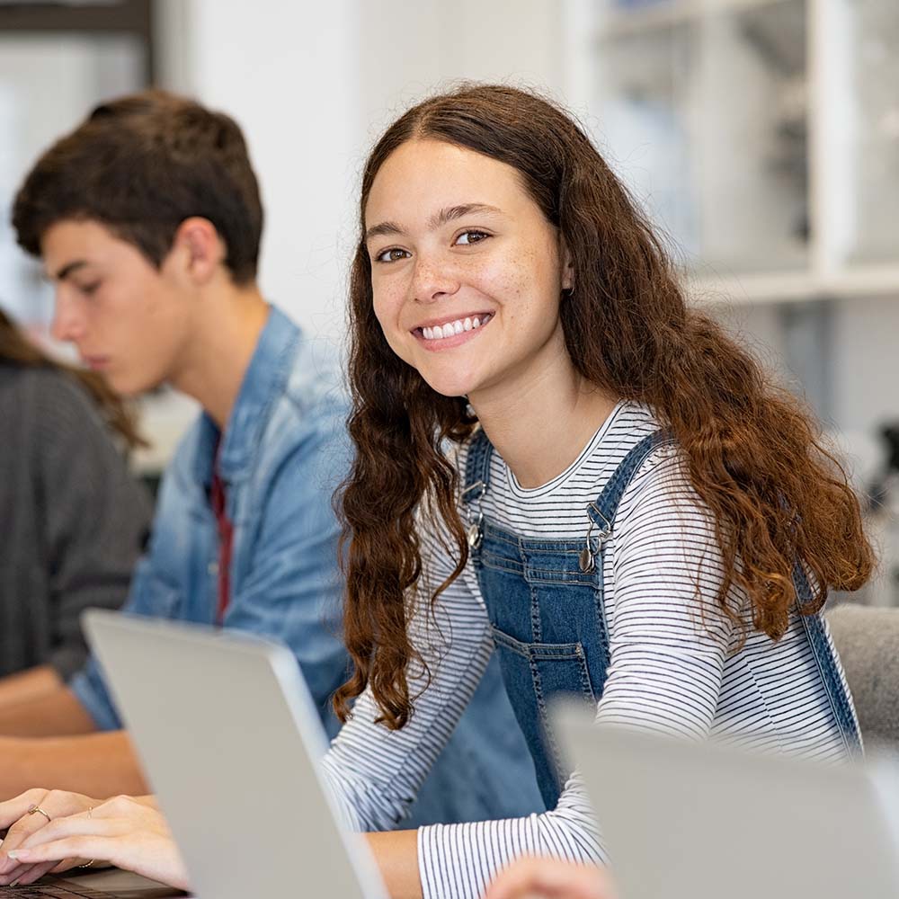 Young students are using laptops in the classroom.