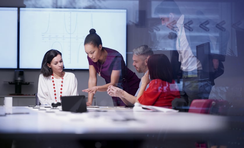 A female consultant meeting with two female and two male clients.