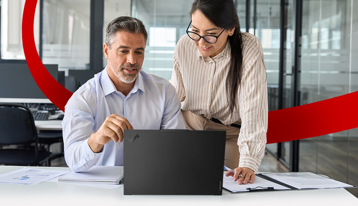 Coworkers collaborating on laptop.