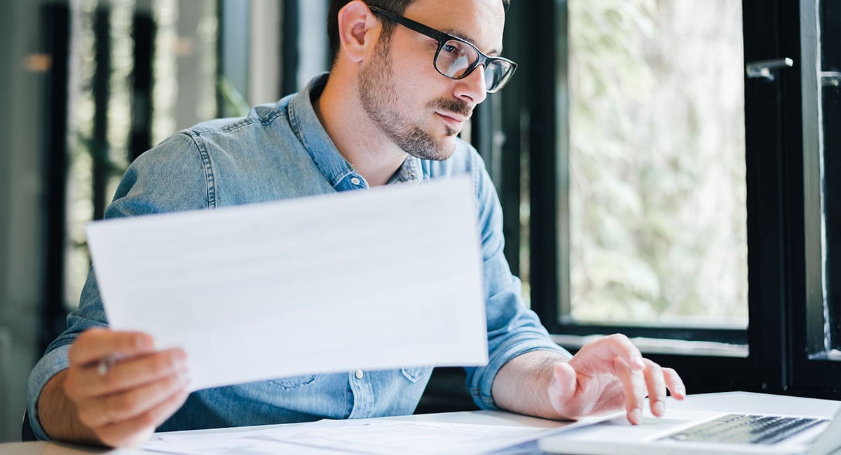 man-analyzes-data-at-desk