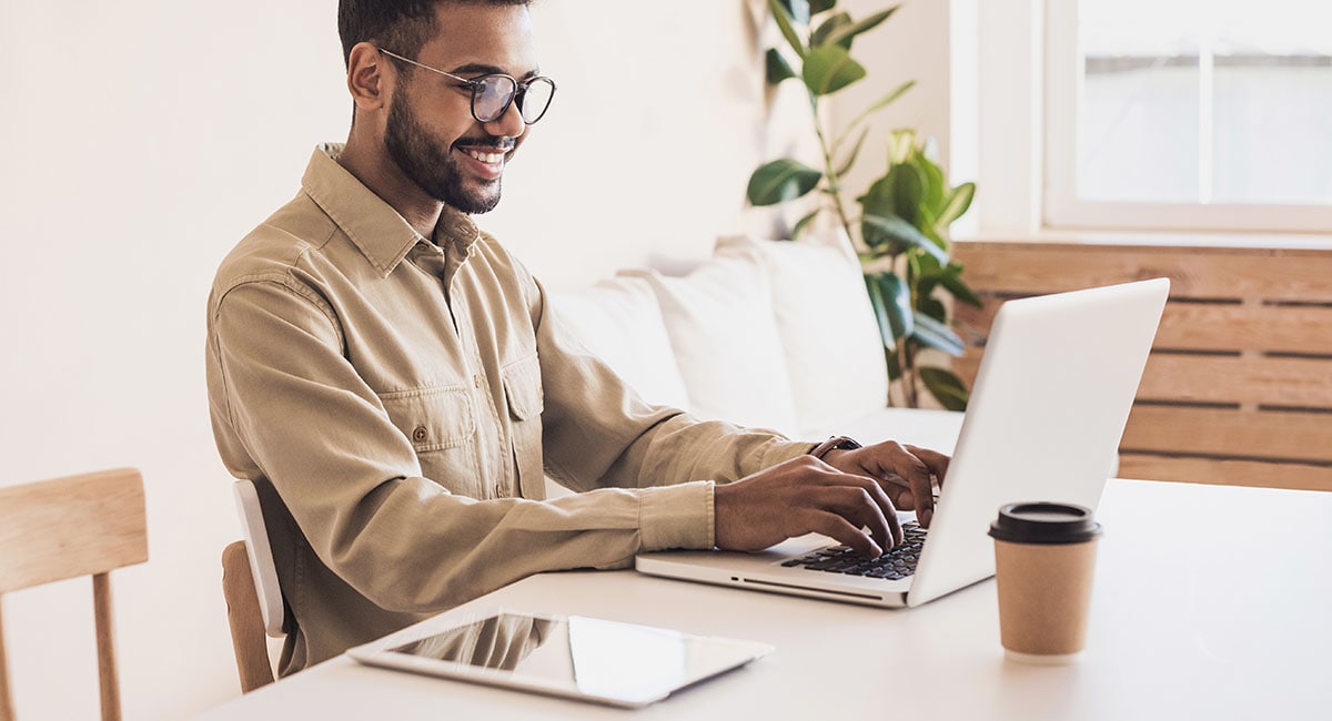 man-working-remotely-with-multiple-devices