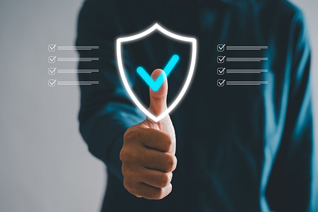 A person selects a check mark within a digital shield graphic, with verification checklists displayed on both sides.