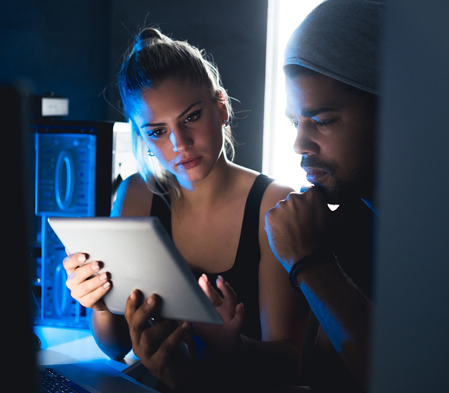 Two people working on a tablet