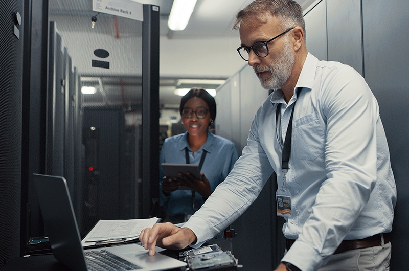 image of two IT specialists working in a data center