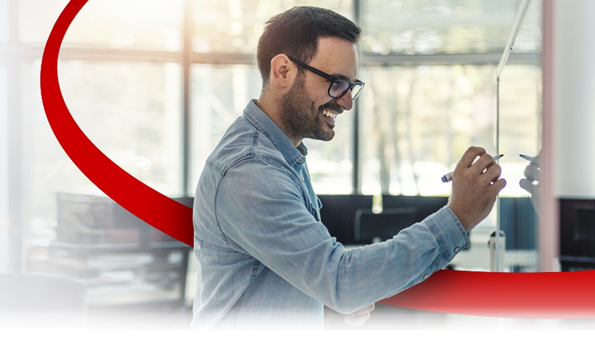 image of a man writing on a whiteboard in an office environment