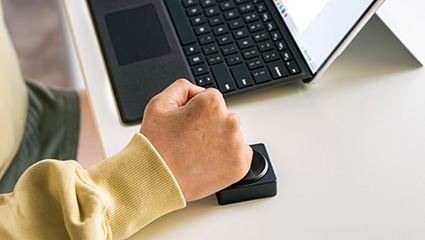 Person using Microsoft's adaptive keyboard buttons.
