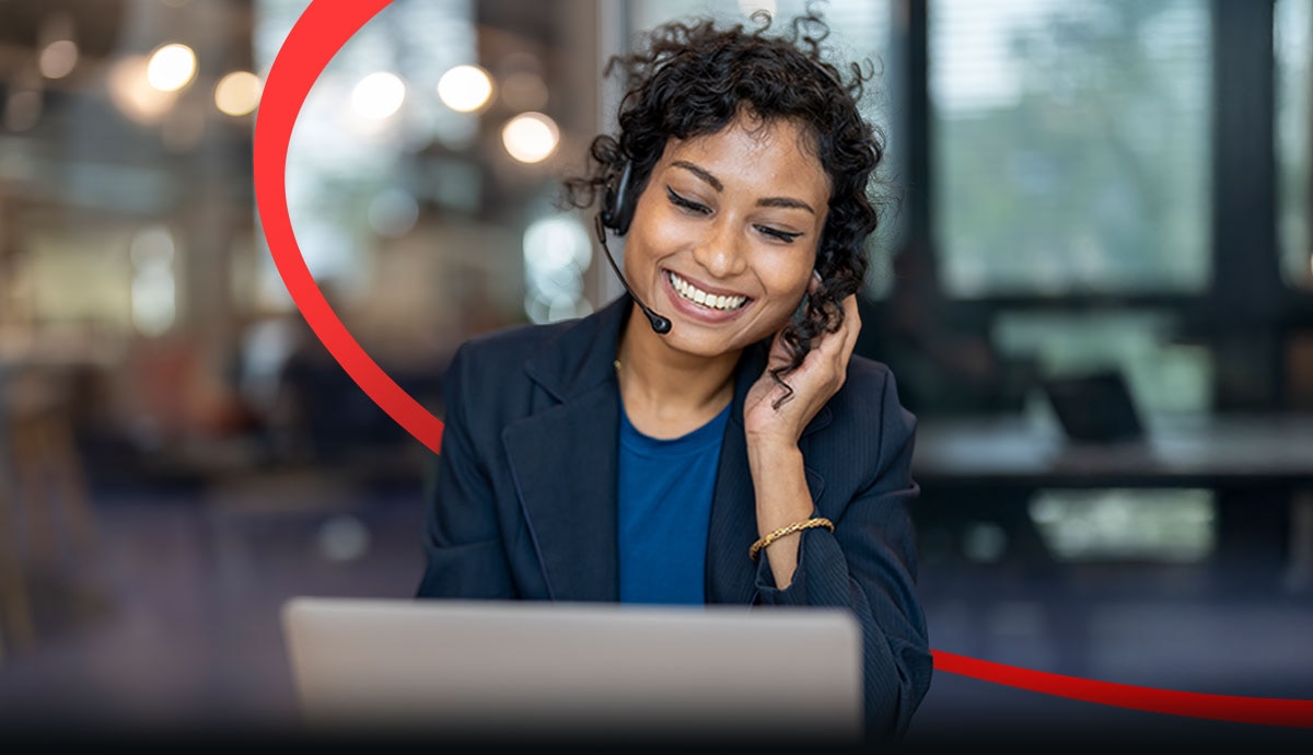 Smiling businesswoman with headset on video call, representing CDW expert support for upgrading from Windows 10 to Windows 11 Pro before October 14 security deadline