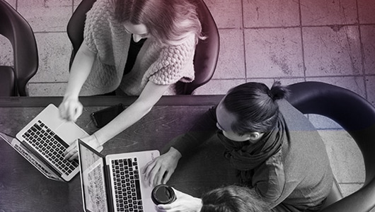 overhead image of a group of employees working on laptop computers