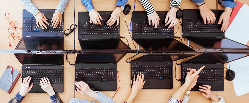 Students using laptops in a school.