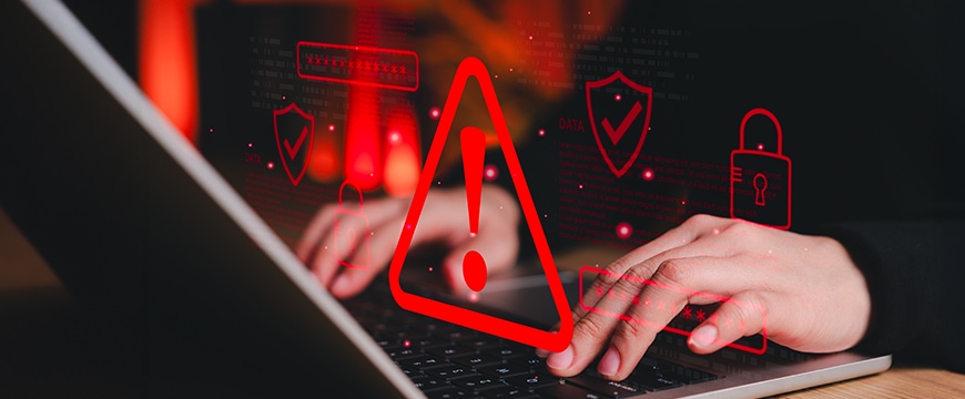 Cybersecurity alert overlay shown on a person using a laptop.