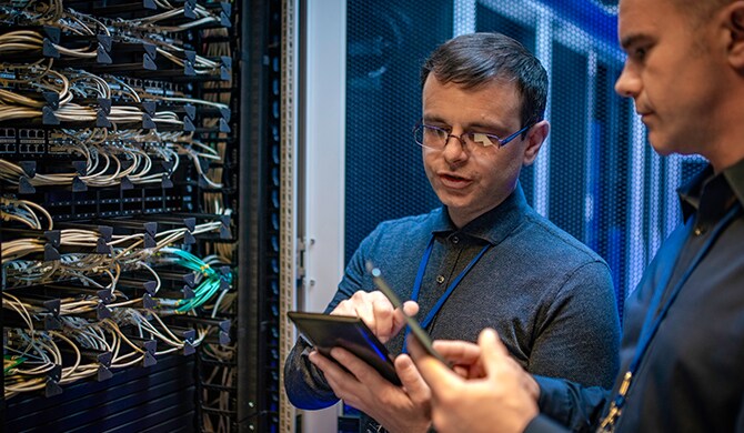 Close up image of two men assessing server configuration.