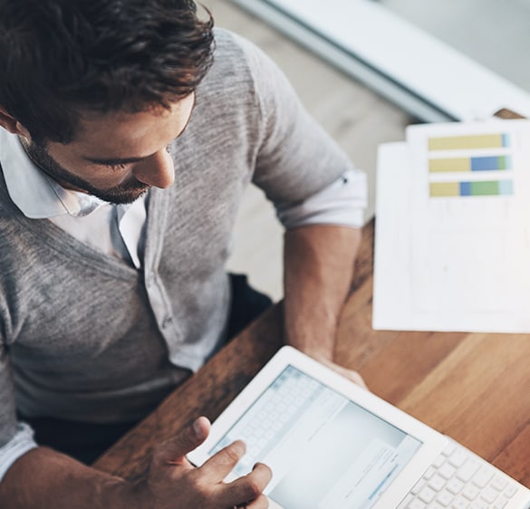 Image of a man working on a tablet device.