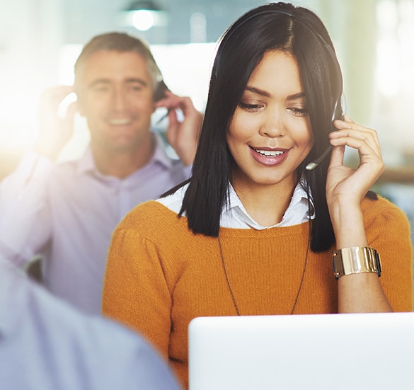 Close up image of a woman talking into headset.