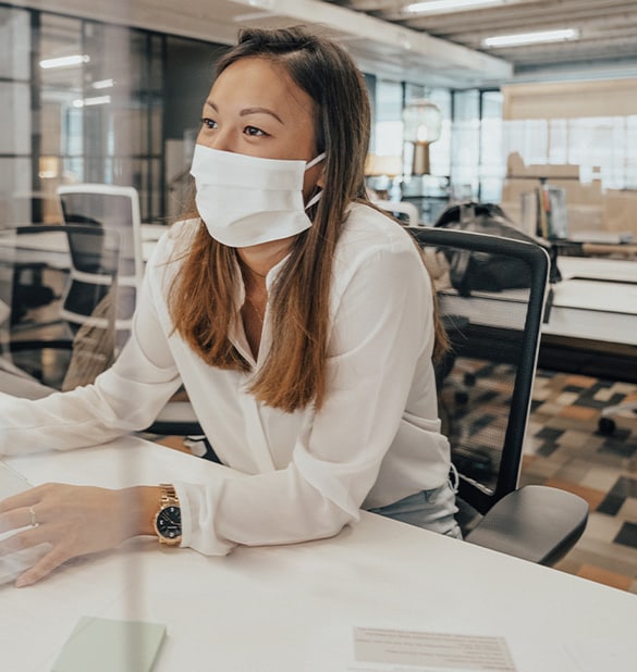 Woman with mask in office setting.
