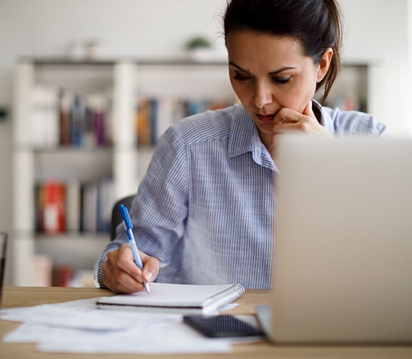 Woman writing on a notepad.