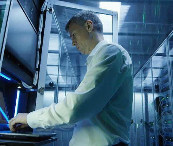 Close up image of a man working on a laptop device..