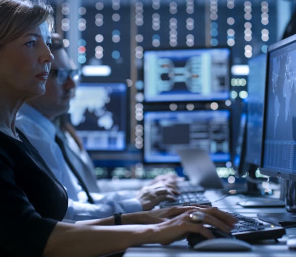 Woman typing on a keyboard and using a computer mouse.