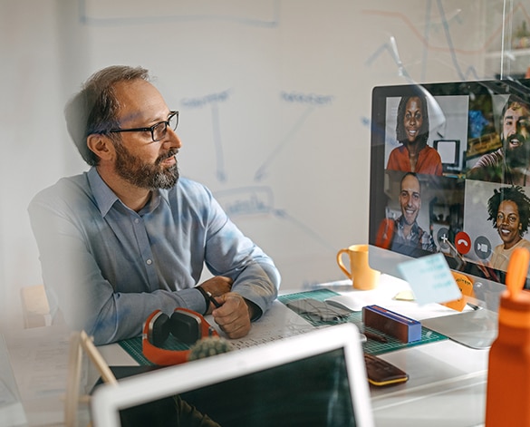 Male teacher attending an online meeting.