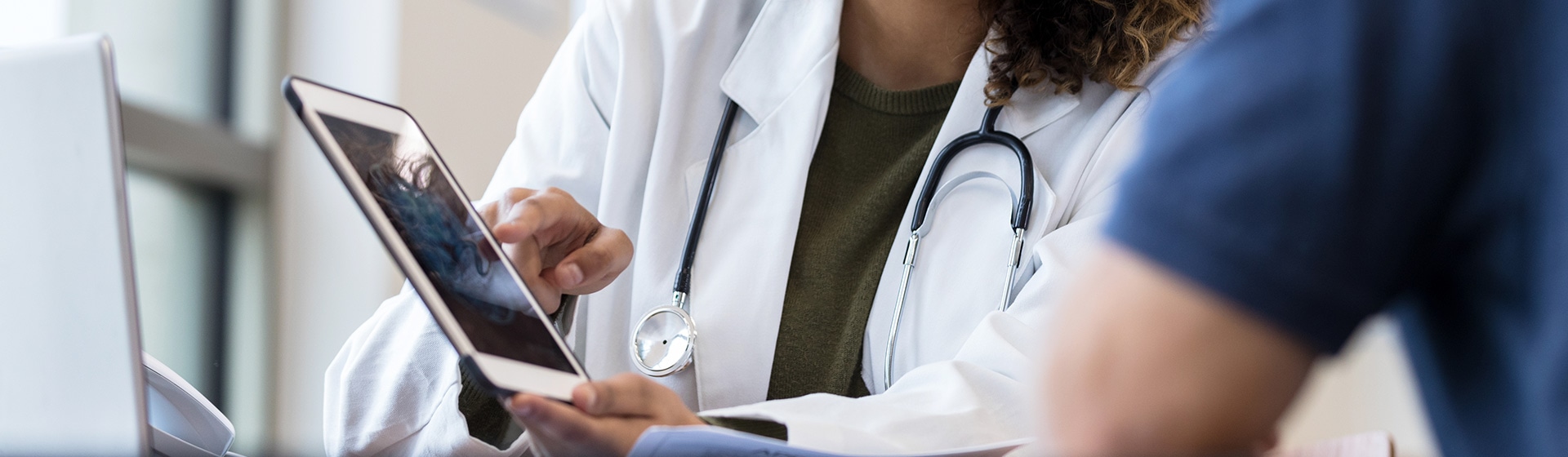 Female doctor using a tablet device.