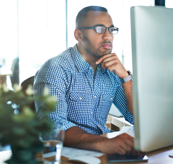 Close up image of a man looking at computer screen.