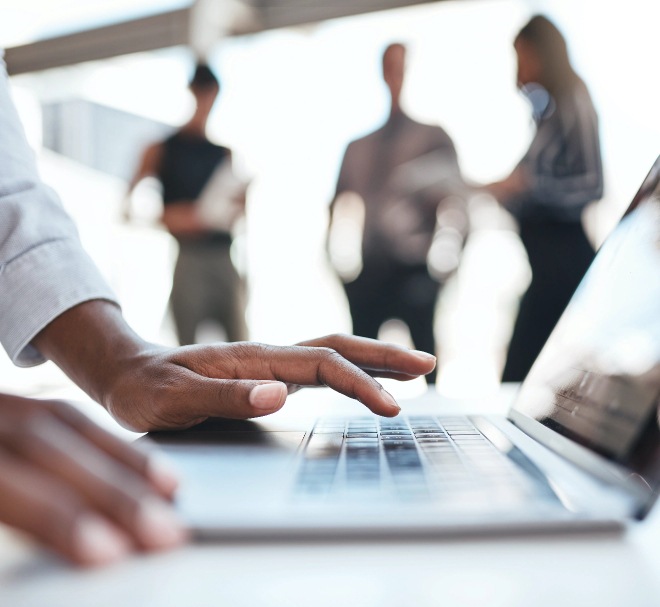 Close up image of a person typing on laptop keyboard.