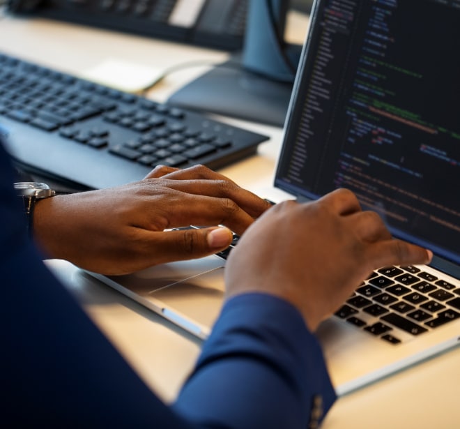 Close up image of a person typing on laptop keyboard.