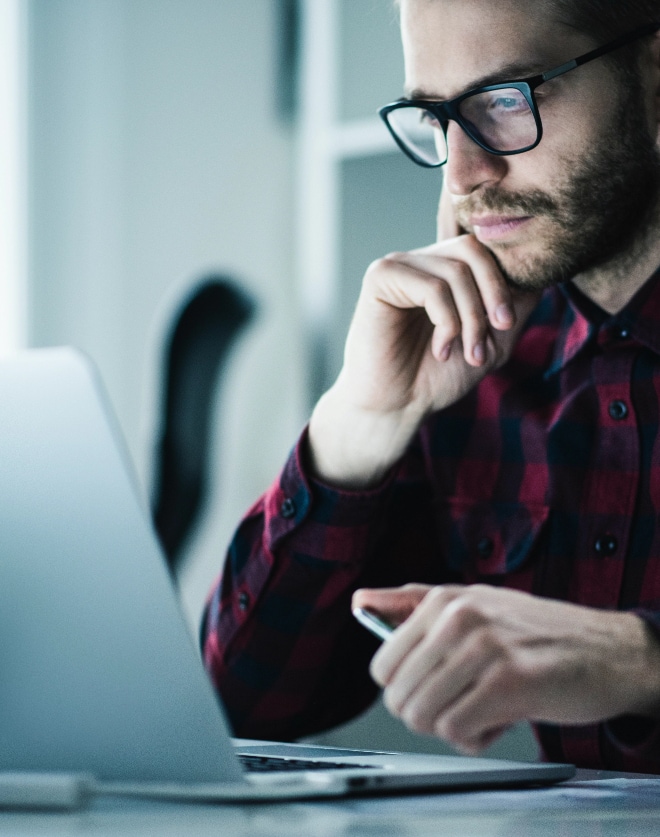 Close up image of a man looking at computer screen.