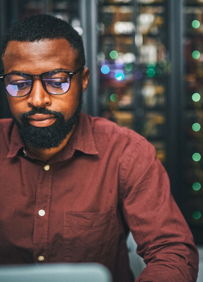 Close up image of a man looking at laptop screen.