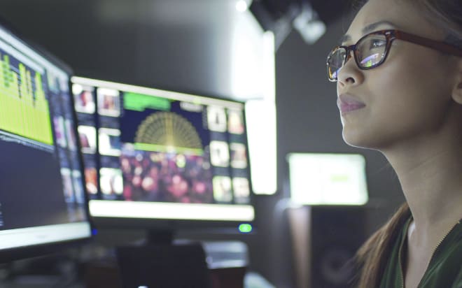 Close up image of a woman looking at computer screen.