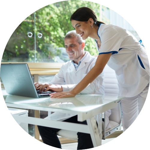 Medical professionals at an office interacting with a computer.