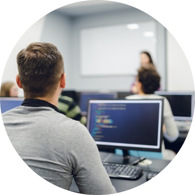 Group of young people training in a computer lab.