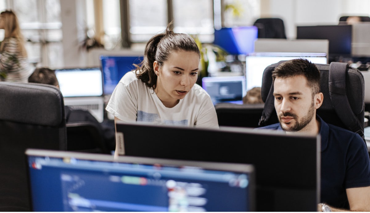 A team of IT professionals collaborate in an office.