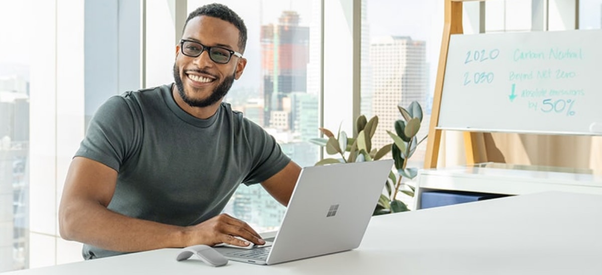 IT professional smiling and working on a Windows 11 equipped device