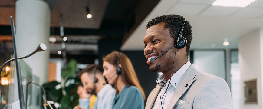 Man with headset looking at a screen