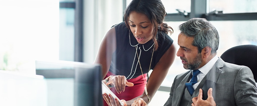 Business colleagues sharing information on an tablet computer