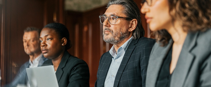 Male and female business professionals attending meeting at office 