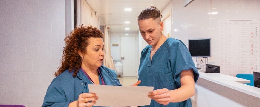 Healthcare workers using paper charts during system downtime