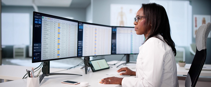 image of a healthcare professional reviewing billing data on a computer monitor