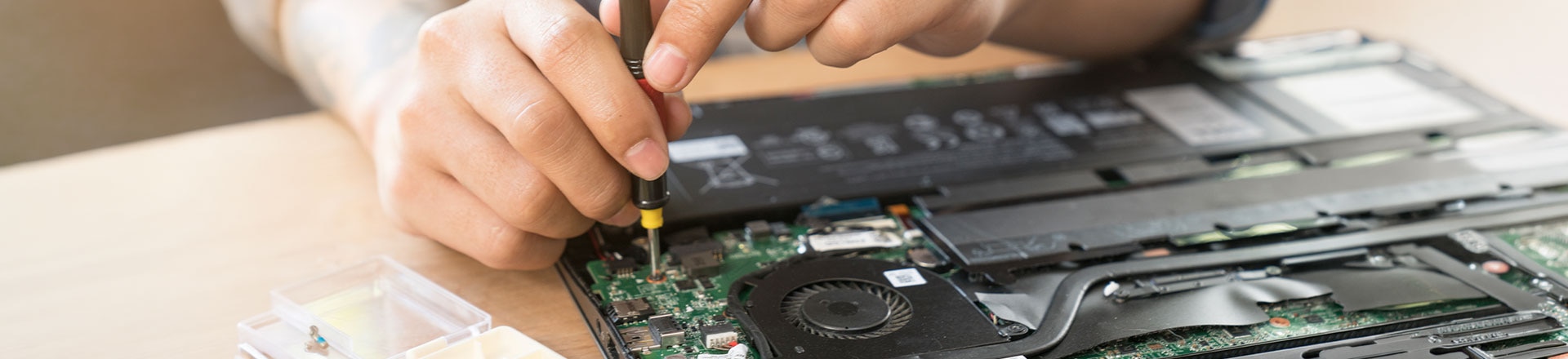 The engineer repairs the laptop (pc, computer) and the motherboard. Installs the equipment (cpu)