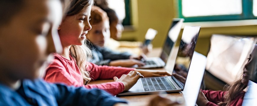 Students using laptop computers during a classroom technology lesson