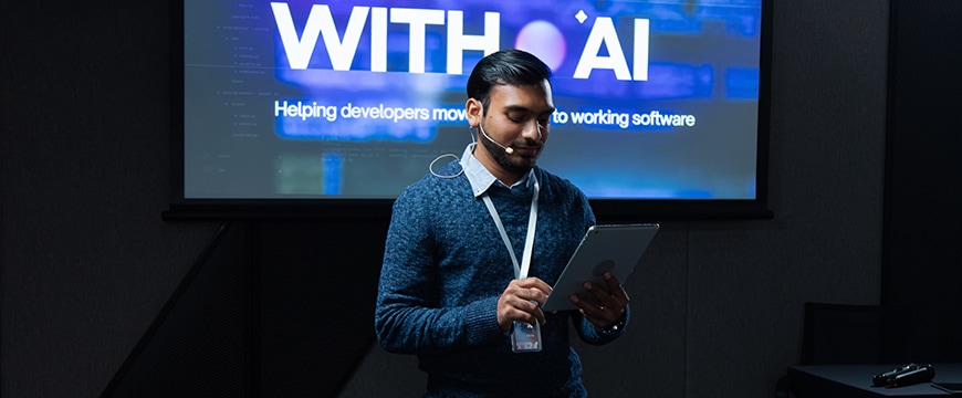 AI technology speaker using tablet during an AI conference presentation