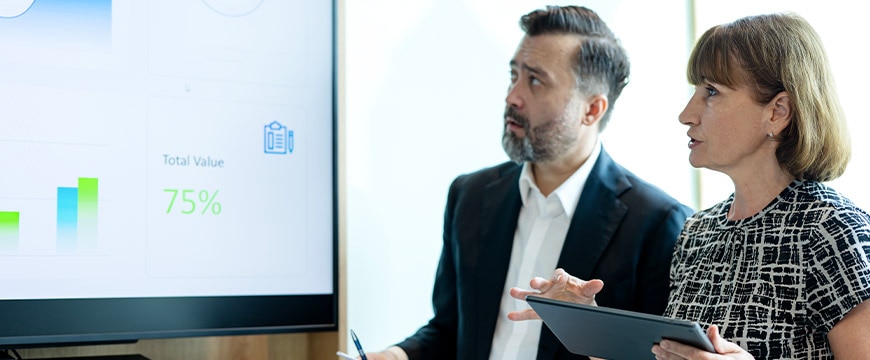 Business Intelligence and Strategy Planning Can Help Empowering and Running Businesses Success. Business Development Executive on the strategic meeting while discussing business insight data on a digital screen in a modern business office.