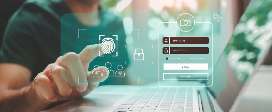 Person using laptop with fingerprint authentication interface and login overlay displayed