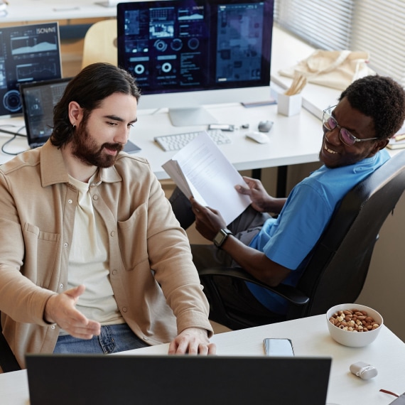 Colleagues review digital analytics while collaborating in a modern office.