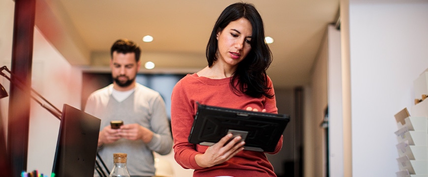 Business professionals in office using tablets and phones with protective cases