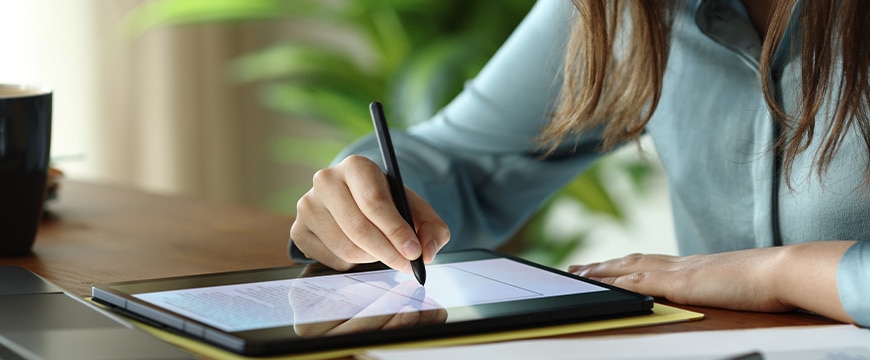 Business professional signing documents with electronic signature pad