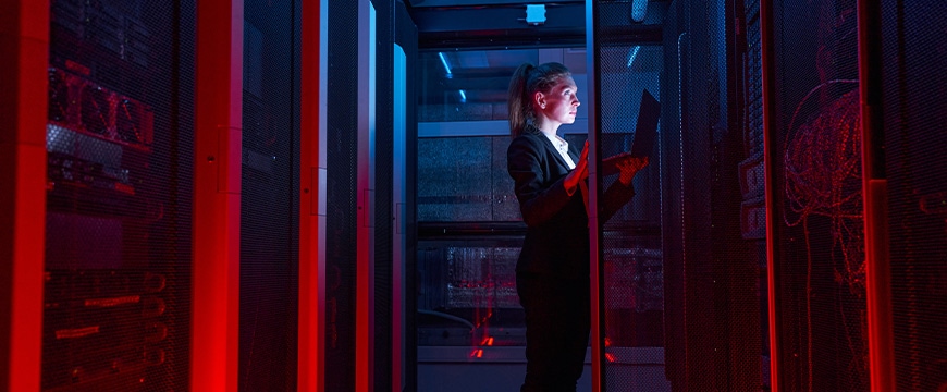 Engineer businesswoman works in network server room