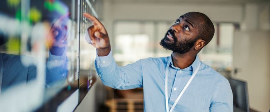 IT security team reviewing access controls on large digital dashboard