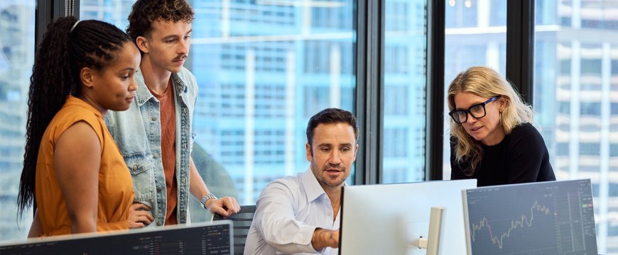 IT security team reviewing data access on multiple screens with employees